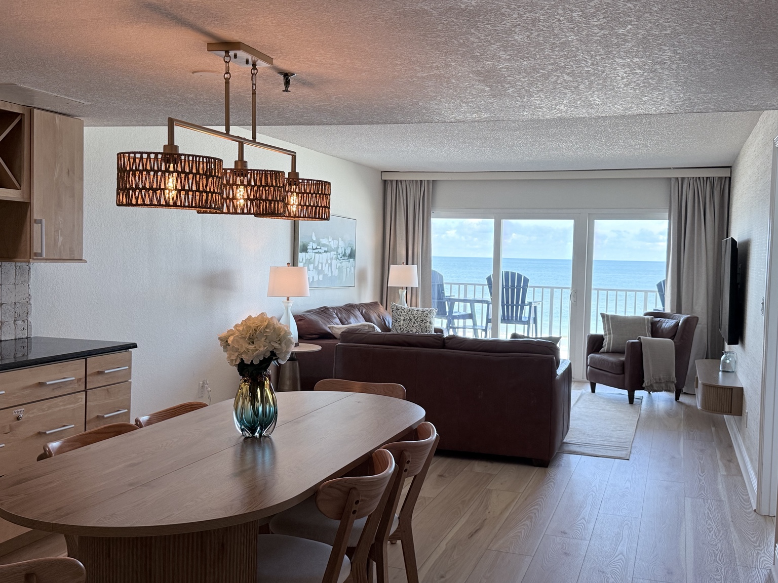 Open-concept dining and living room with a Gulf view at Seagate 207
